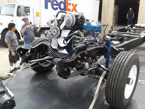 Angled view of engine and drivetrain on restored chassis