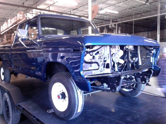 Final assembly stage showing painted body with front end components