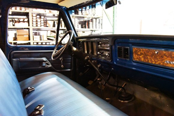 Restored interior showing dashboard, seats, and wood grain trim